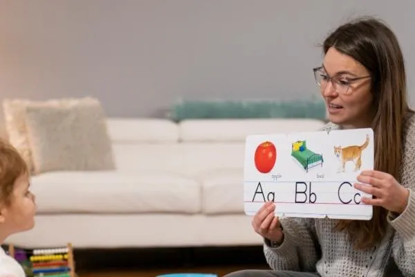 a woman teaching a child