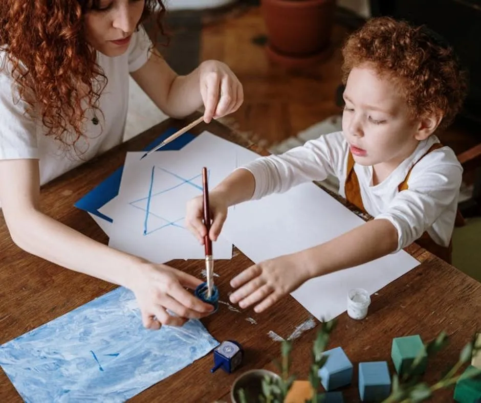 a woman and a child drawing a star
