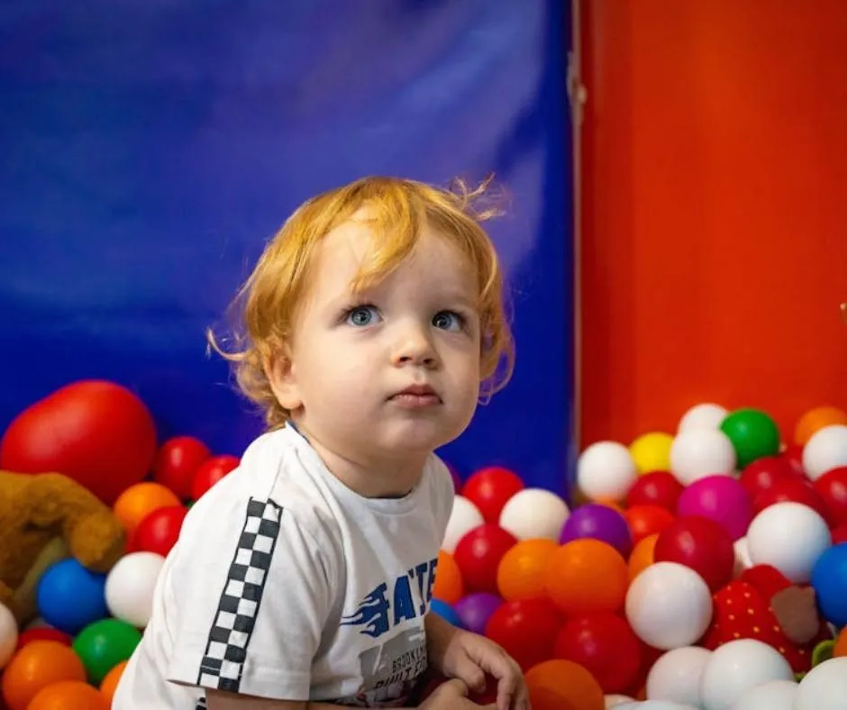 a child playing in ball pit