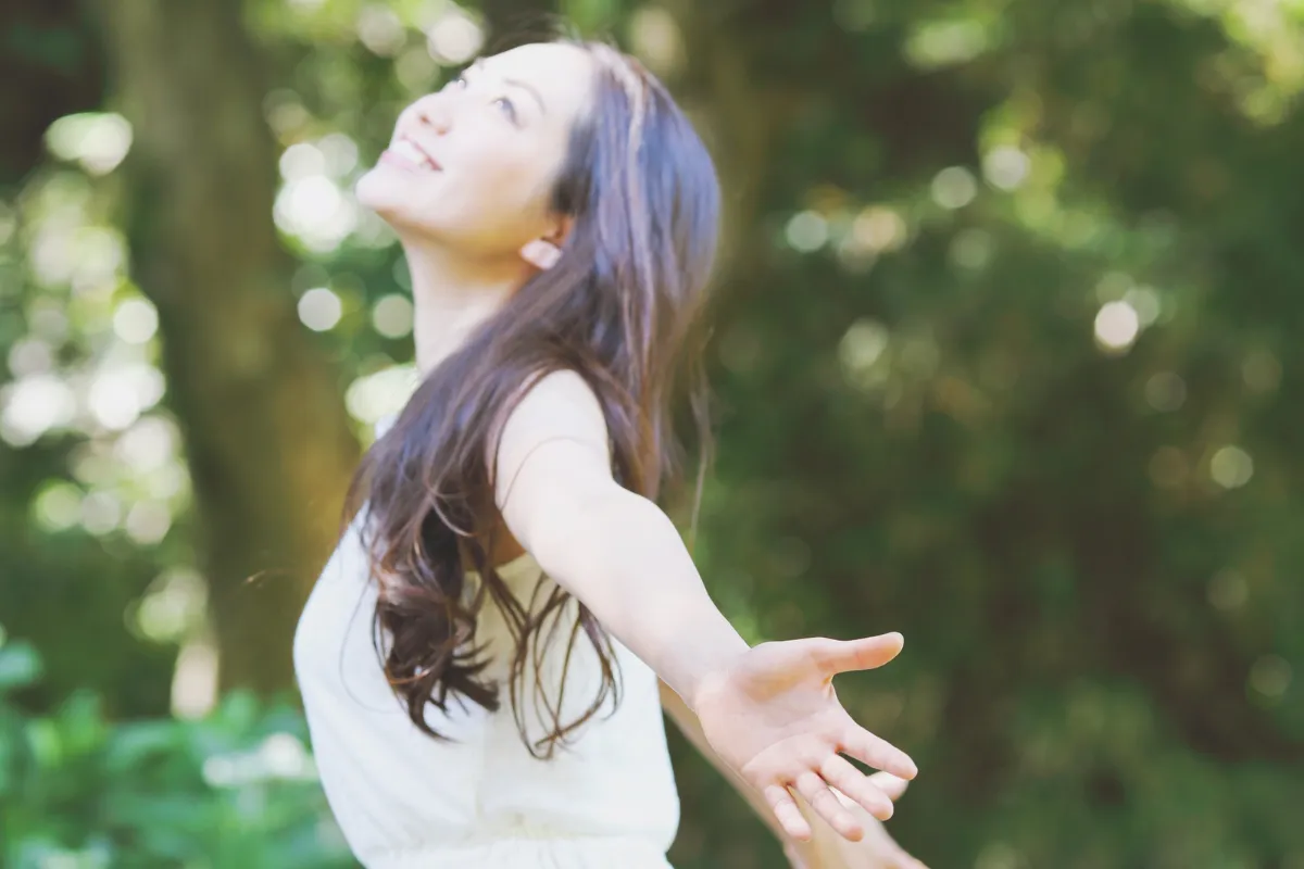 Woman in nature representing inner peace, emotional healing, and self-compassion journey.