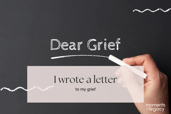 Black chalkboard with a hand holding a piece of chalk, writing the words “Dear Grief” in white chalk. Below, text reads “I wrote a letter to my grief.” The image conveys reflection, healing, and emotional expression. Keywords: grief, healing, writing therapy, coping with loss, self-expression, journaling.