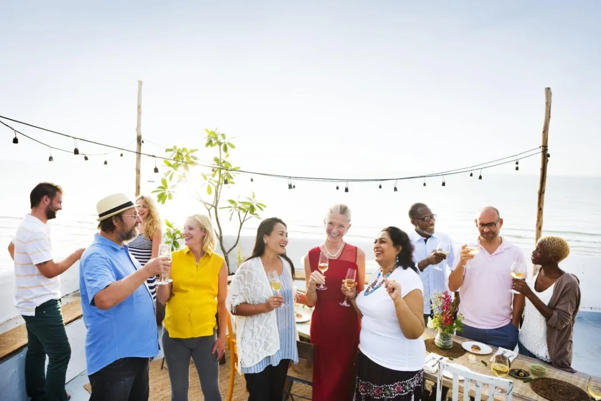 Shores Kitchen Santa Monica- scenic rooftop with people have drinks and smiling