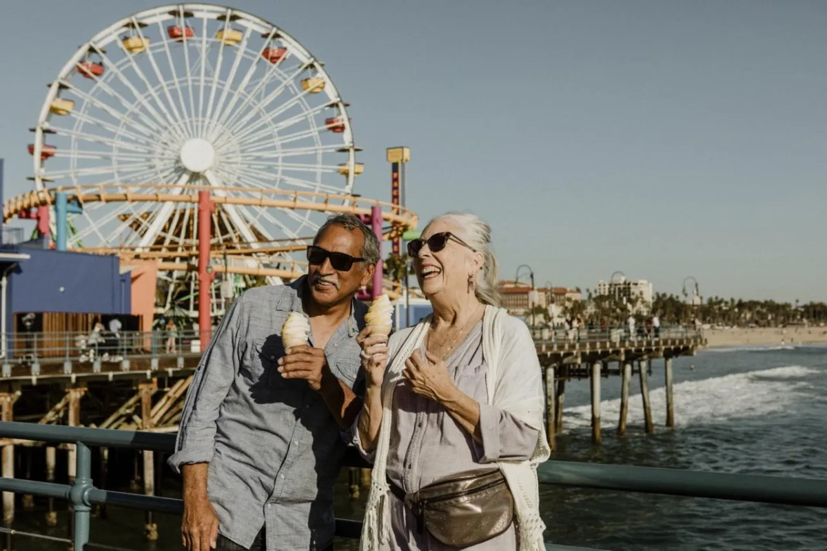 Shores Kitchen Santa Monica- older couple smiling at pier and having ice cream