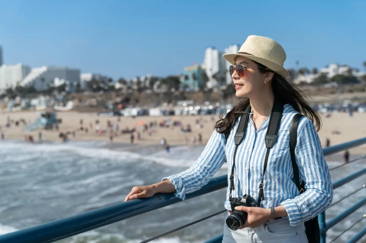 Shores Kitchen Santa Monica- woman looking out from pier at ocean view in Santa Monica