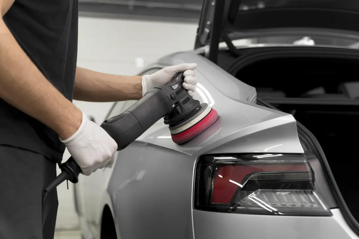 Close-up view of ceramic coating being applied to a car's exterior.