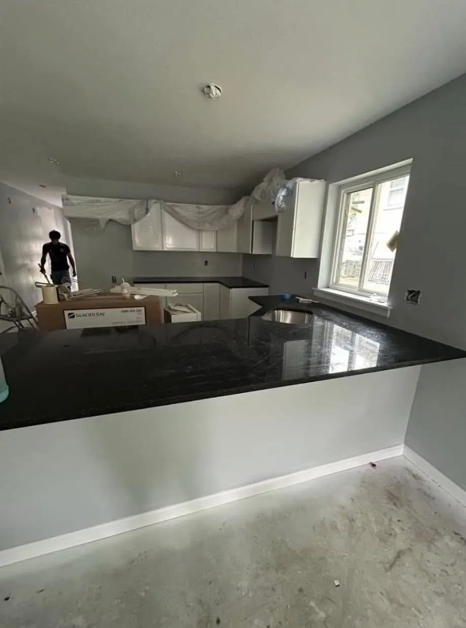 Kitchen with black granite counters. In progress