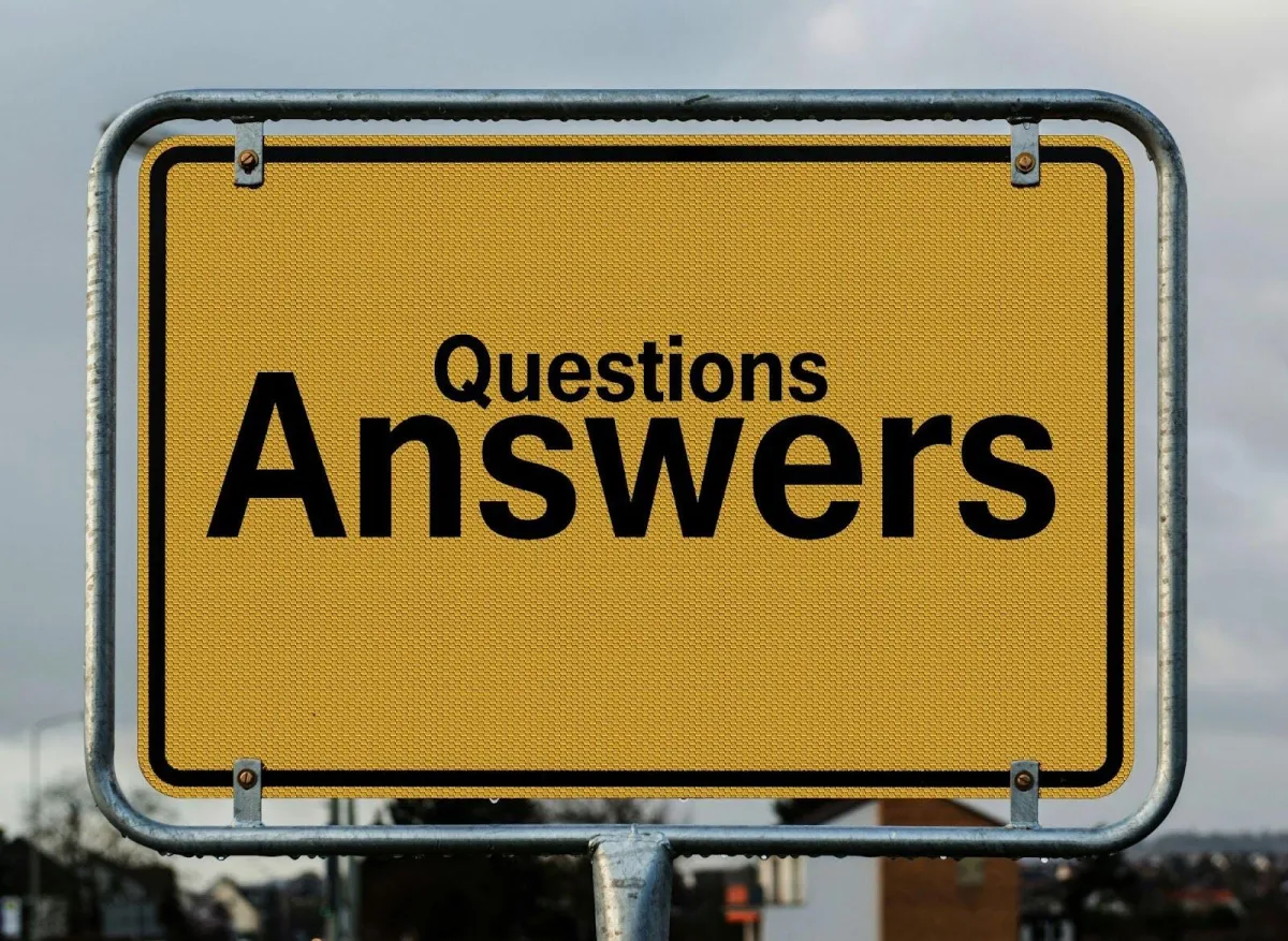Interview questions and answers guide - yellow road sign displaying 'Questions Answers' for job interview preparation