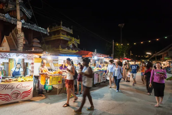 Image of a local guide leading a group through an Asian market