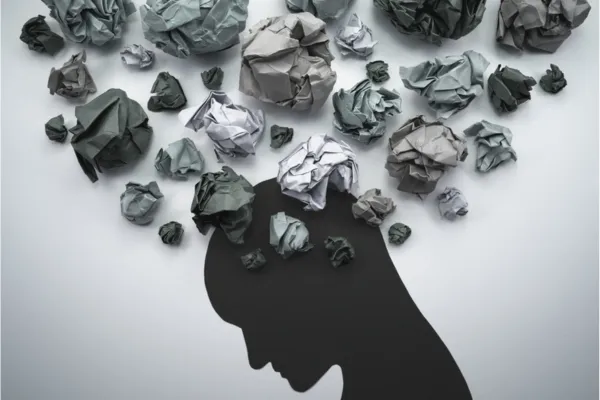 Person holding their head in distress, representing brain fog and neurological symptoms caused by mold exposure that mimic trauma.