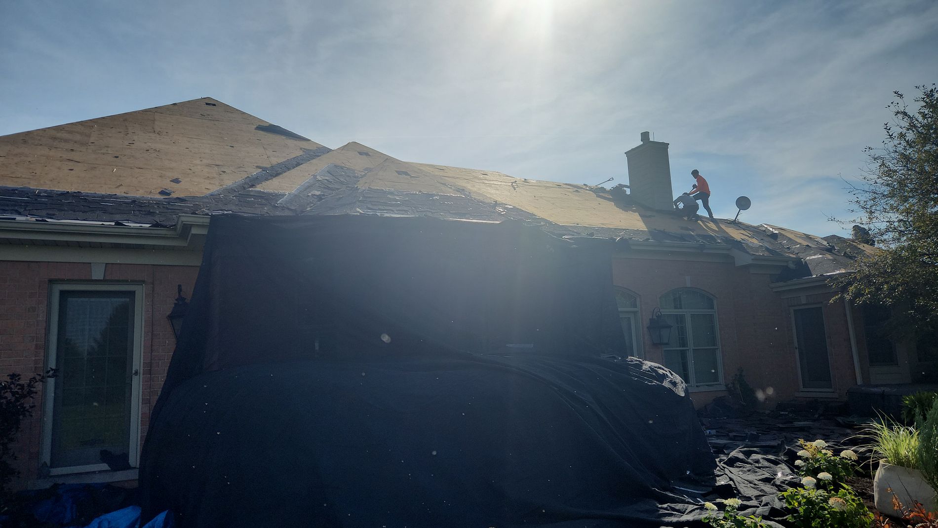 Emergency roof tarping on a home in Harvard Illinois during roof replacement