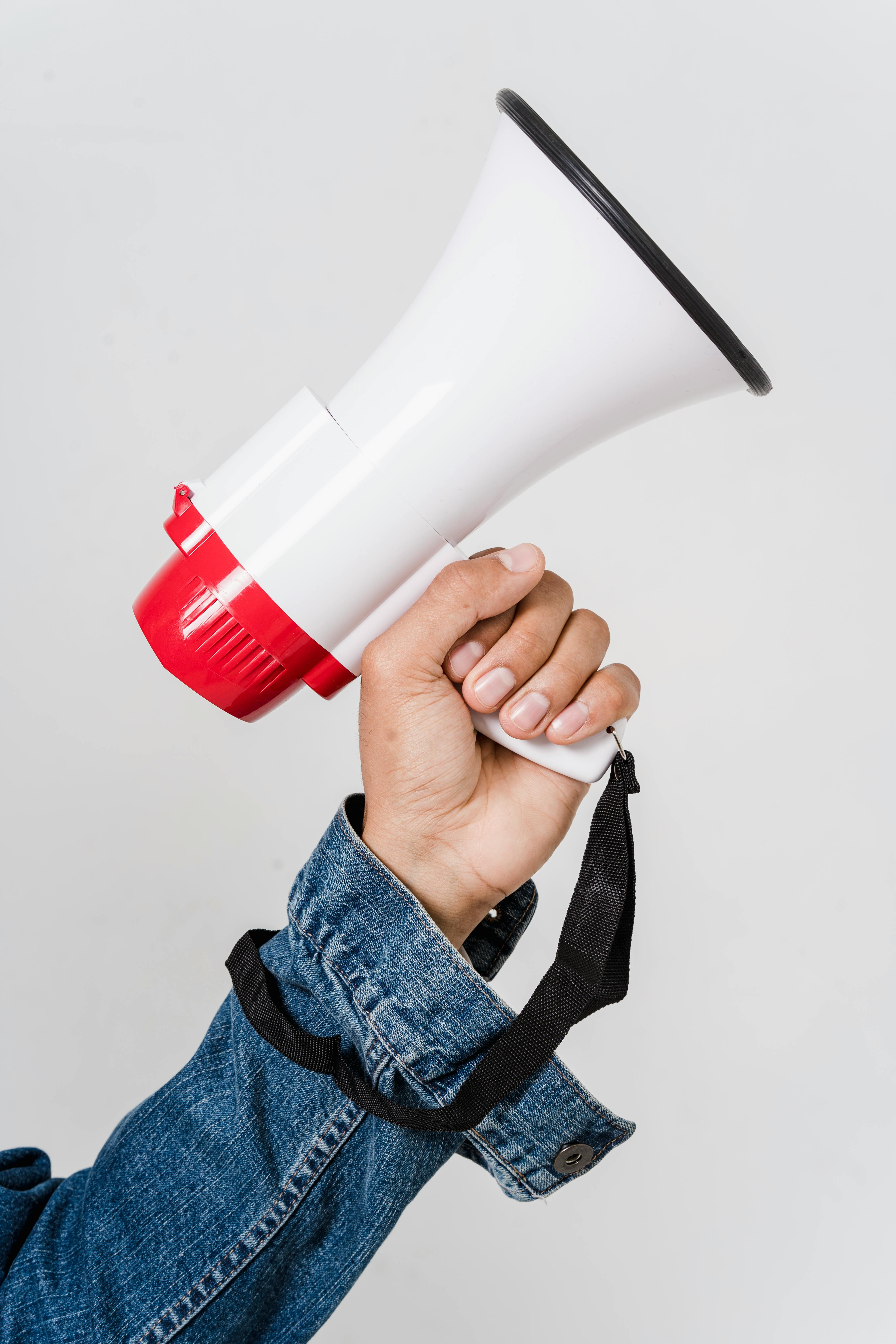 Man In Blue Denim Jacket Holding A Megaphone