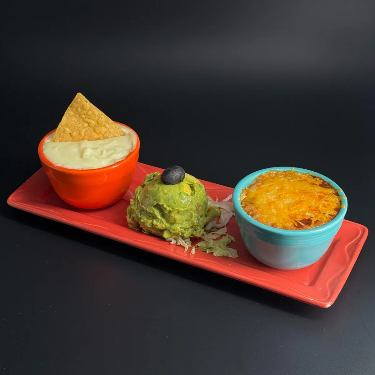 Mexican Trio appetizer at Casa de Bandini — fresh housemade guacamole, jalapeño cheese sauce, and Mexican bean dip with salsa Quemada in Carlsbad CA
