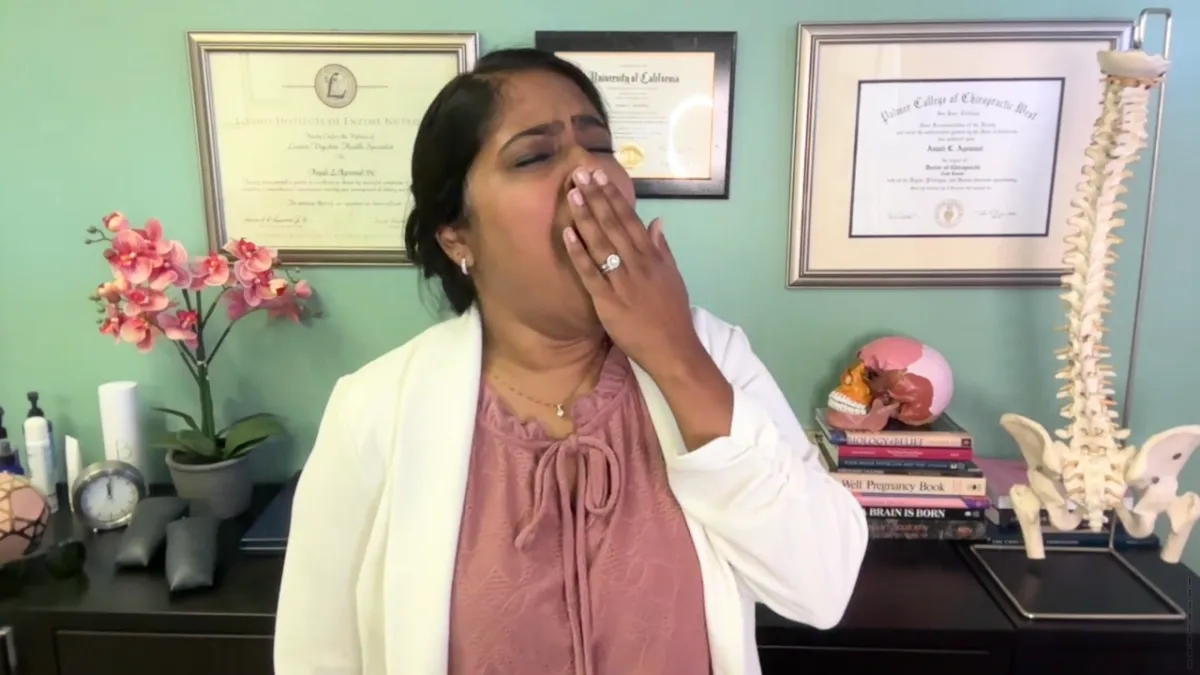 Dr. Anjali Yawning to signify exhaustion