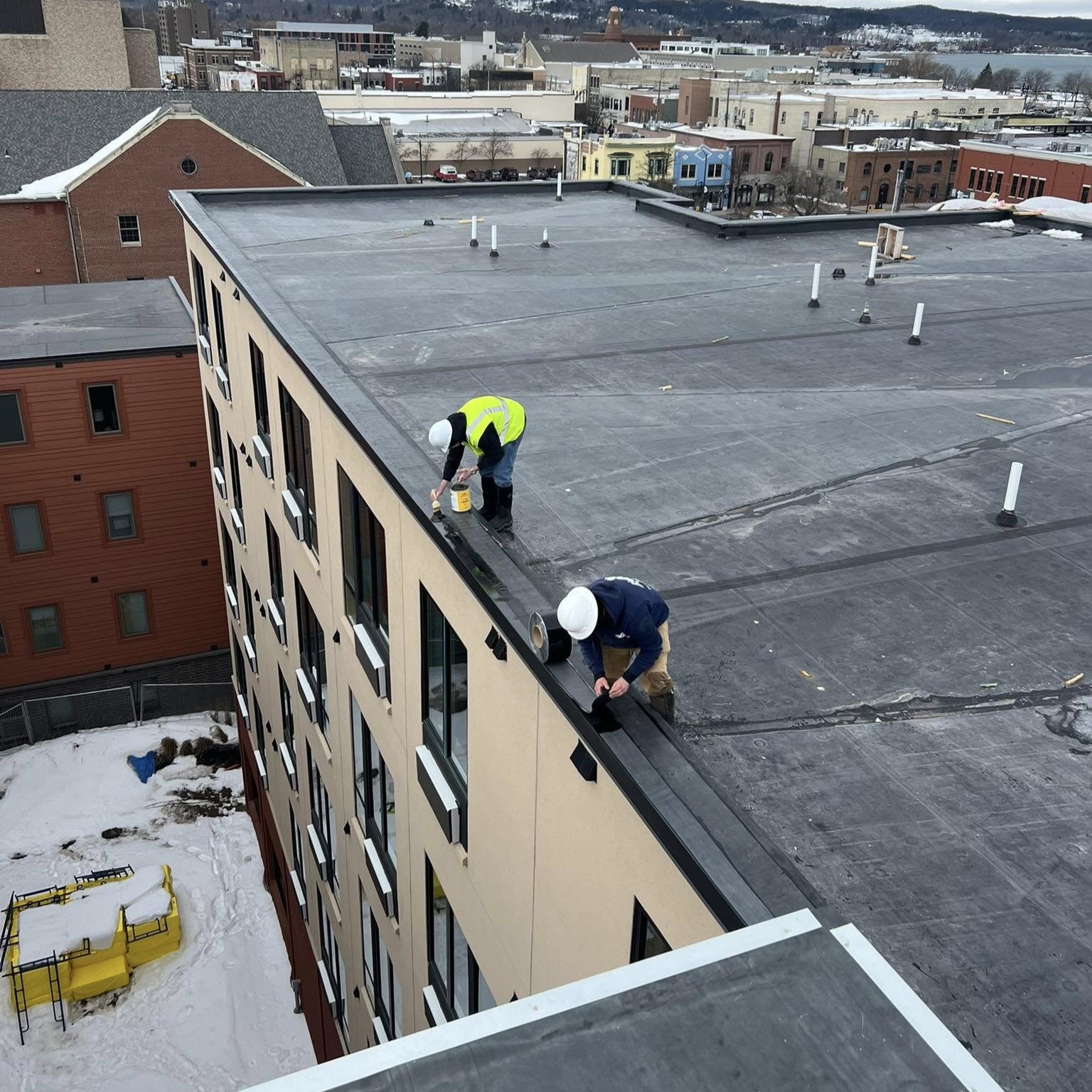 K&M Roofing patching an apartment building