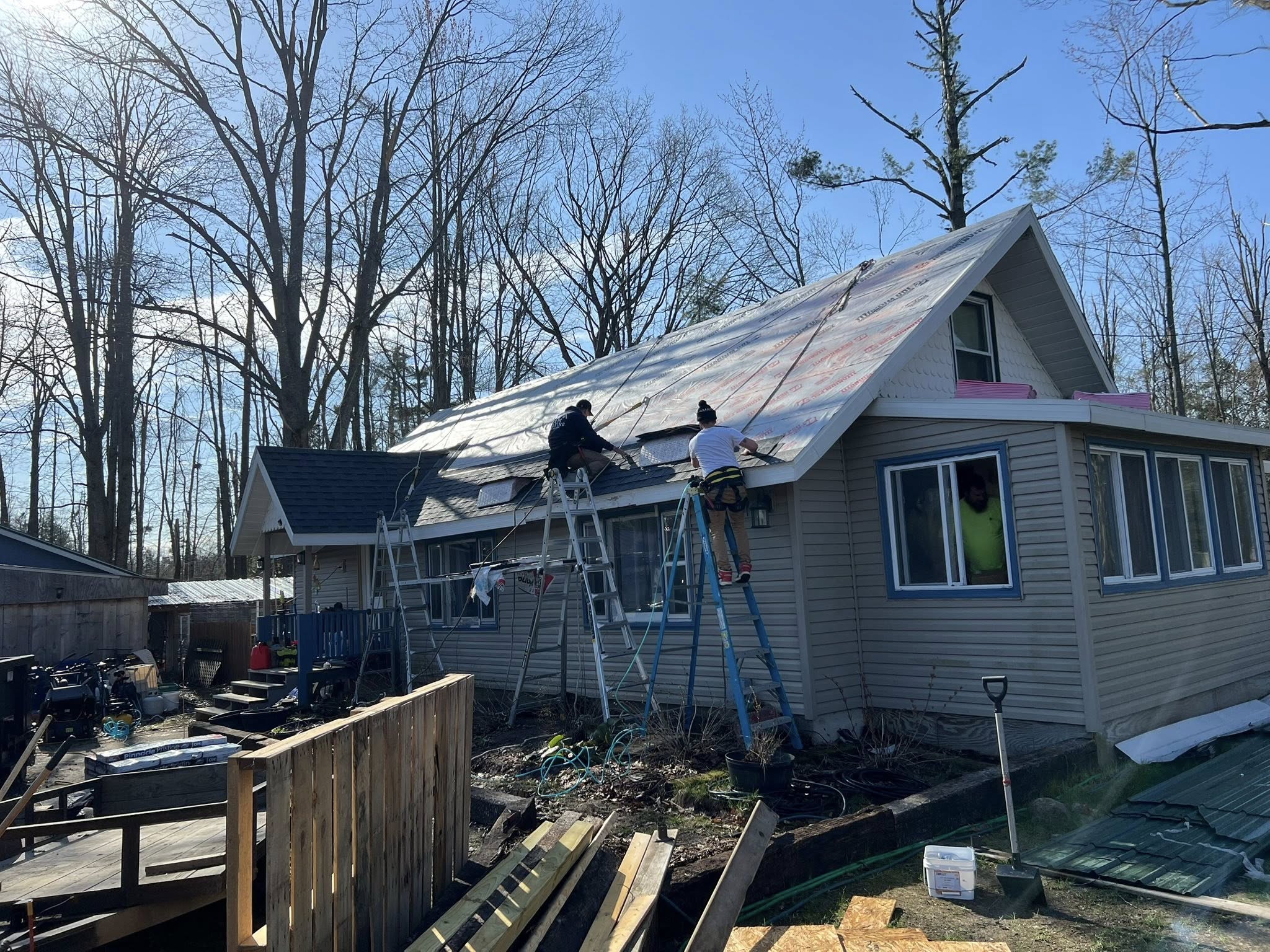 The K&M team repairing a roof