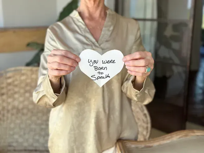 Lynn holding a heart saying you were born to speak