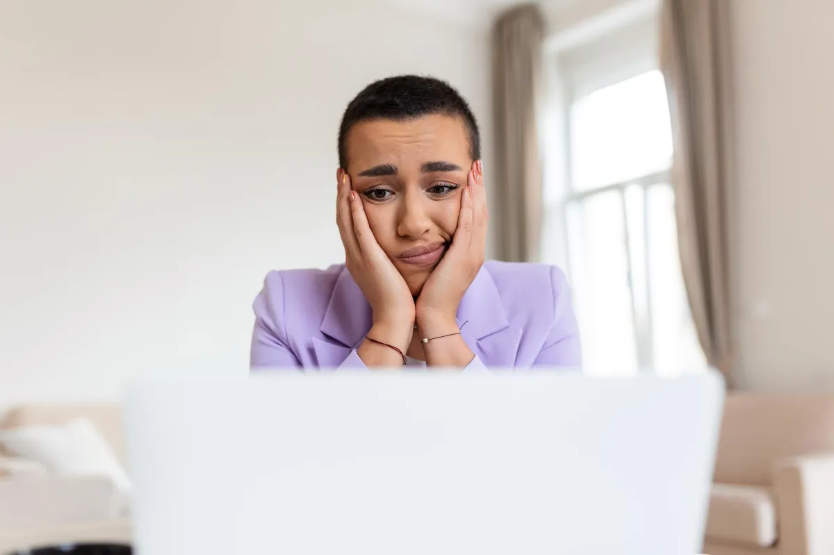 a frustrated woman in front of her laptop