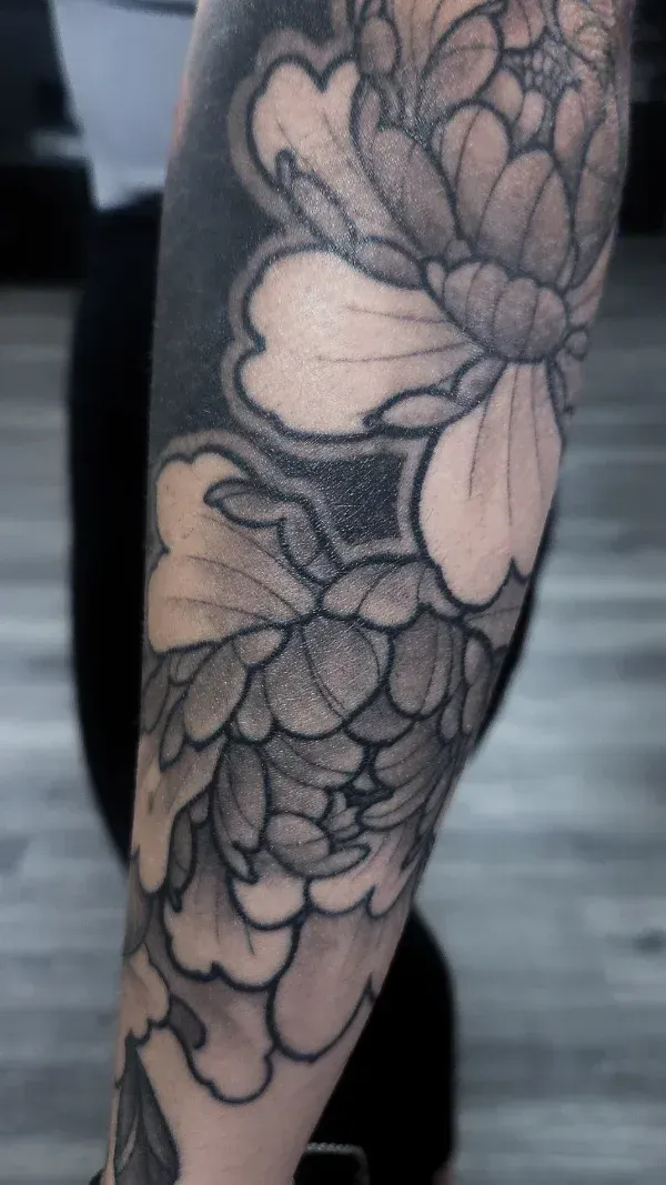 Mellow Peonies and a black background black and gry floral tattoo: Professional tattoo by Mickey Schlick at Montana Tattoo Company in Missoula, MT 
