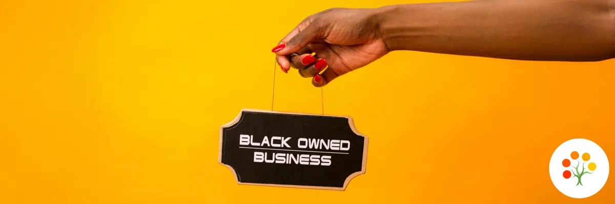 an arm holding a small sign that says "black-owned business"