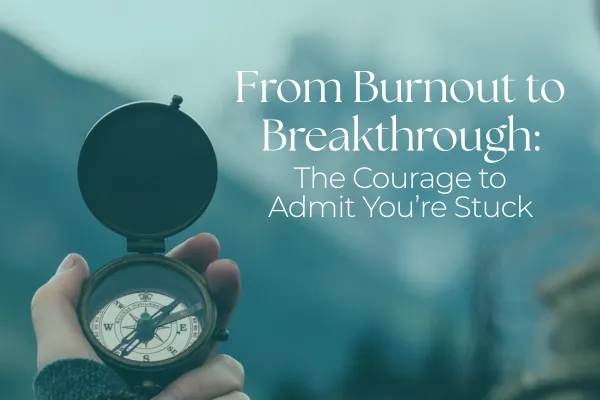 A woman's hand holding a compass up outdoors in nature