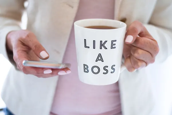 Woman with a "Like A Boss" coffee cup