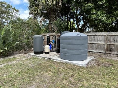 Advanced water purification system with blue filters and glass, showcasing essential well water filtration solutions
