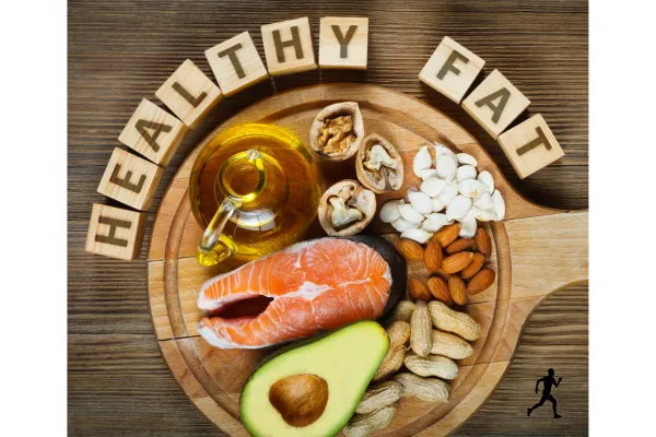 Image of foods that contain healthy fats including salmon, avocados, olive oil, peanuts, almonds, pumpkin seeds and walnuts.