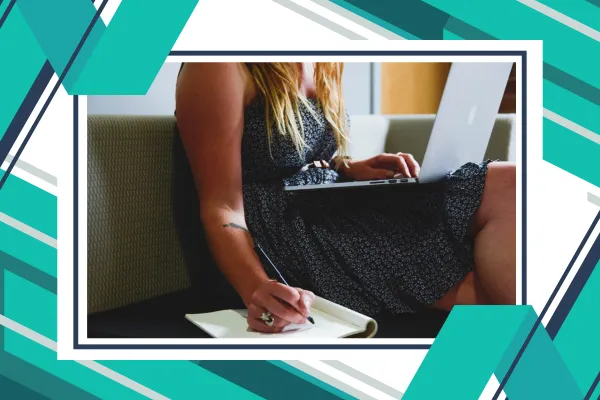 Women sitting with her laptop planning on a notebook next to her.