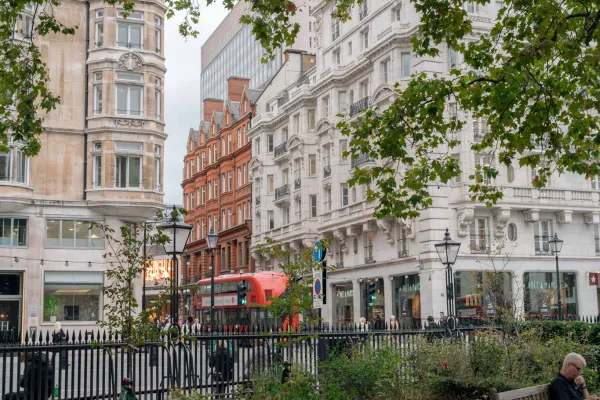 View of London Mayfair with iconic red bus, showcasing the bustling and beautiful city centre.