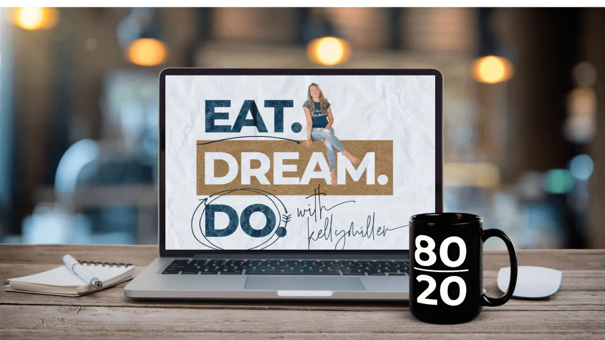Laptop on table showing Eat. Dream. Do and 80.20 Coffee Mug