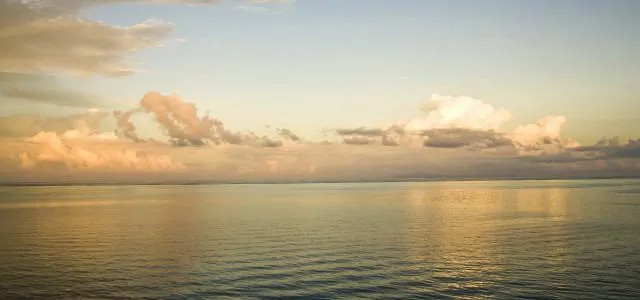 Flat serene lake at sunset