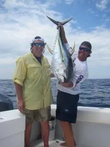 2 guys holding a sailfish