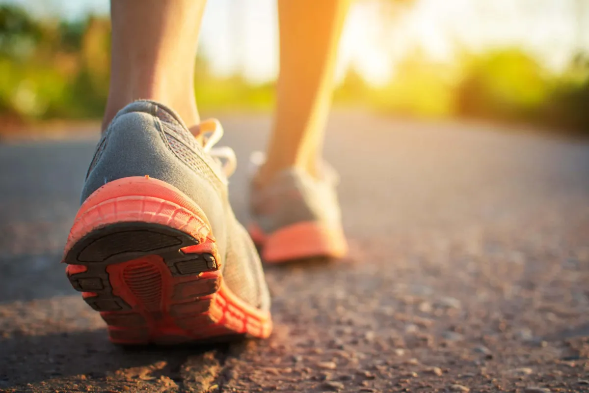 Close-up of running shoes as a person walks.