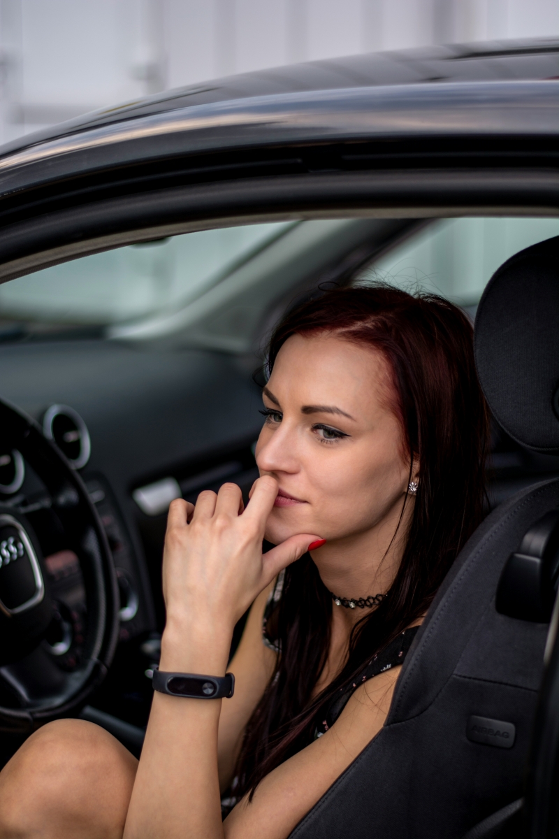 women in a car reflecting before a holiday party