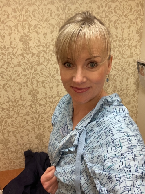 Christi in a hospital gown, ready for a mammorgram