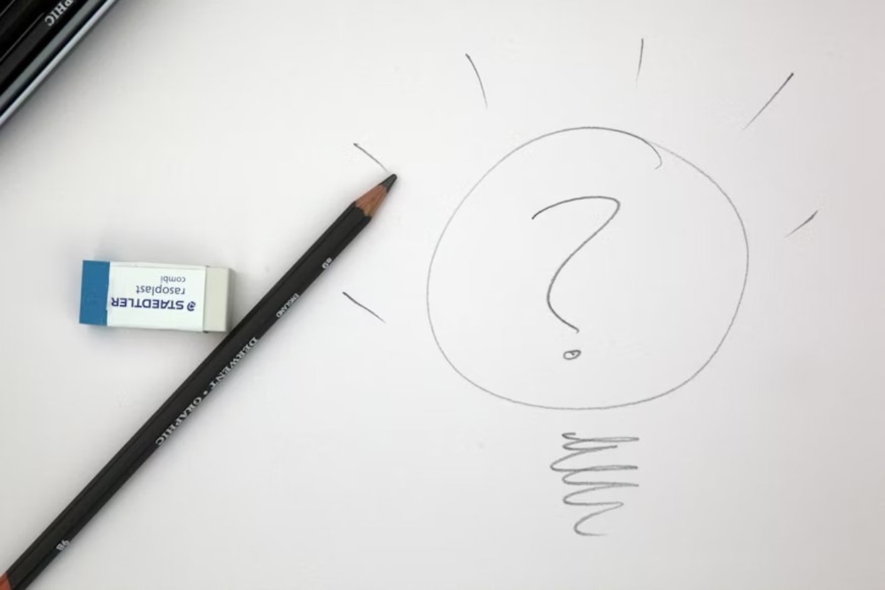 An idea bulb drawn with a pencil with a question mark in it
