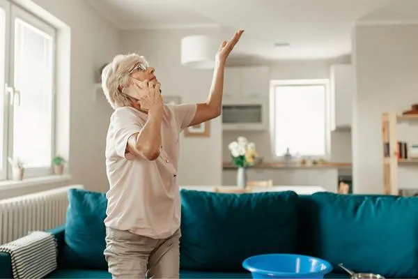 Lady with bucket and leaking roof
