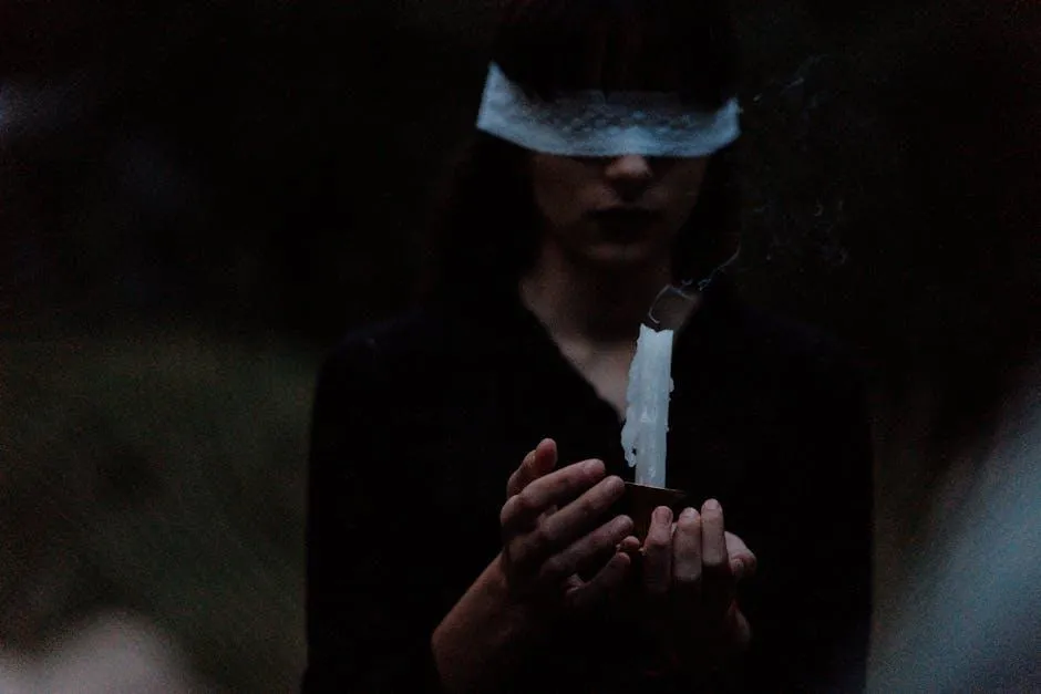 woman holding a candle blindfolded
