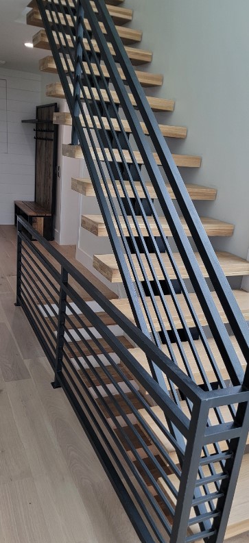 Architectural metal stair railing showcasing custom welding craftsmanship in Ponte Vedra Beach Florida residence