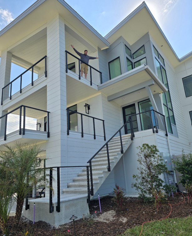 Front exterior of beach house with first and second floor custom bannisters and stair railing leading to driveway in Ponte Vedra Beach FL
