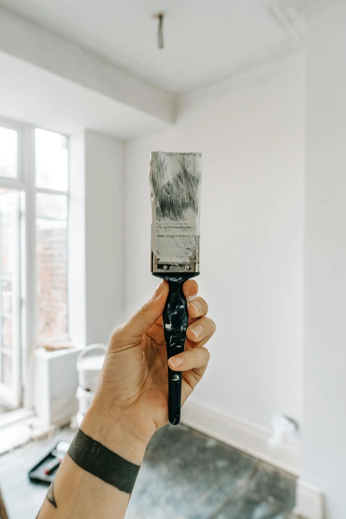 A paint brush in a freshly painted room.