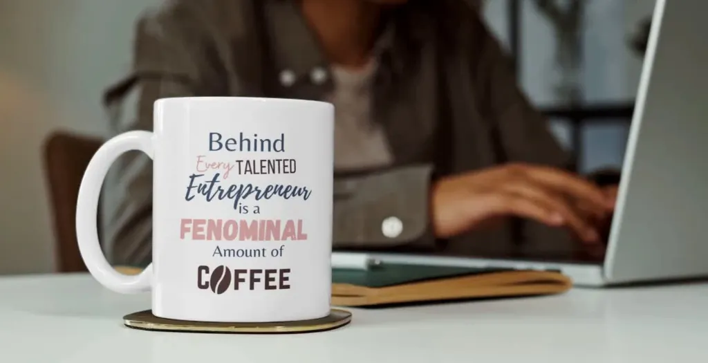 Cassandra's New Mug Design on a desk of a woman entrepreneur working on laptop