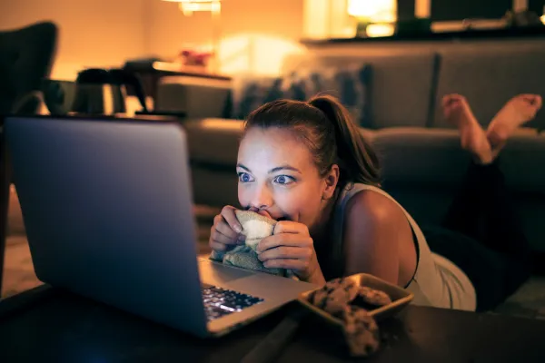 Women watching rom-com on laptop