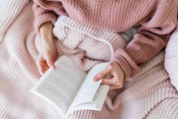 woman holding a book reading love languages