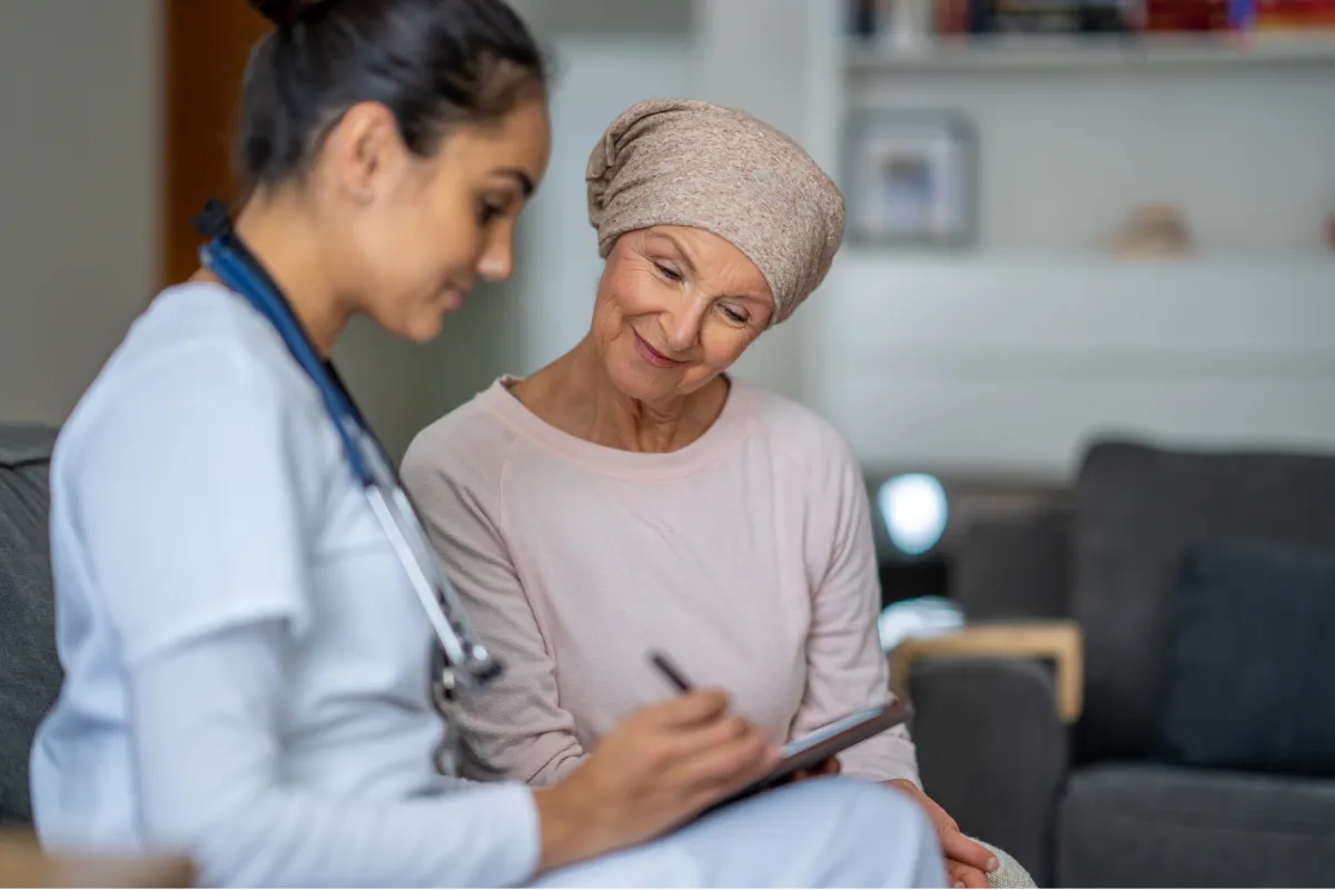 A healthcare professional discusses treatment options with a patient in a cozy, softly lit room.