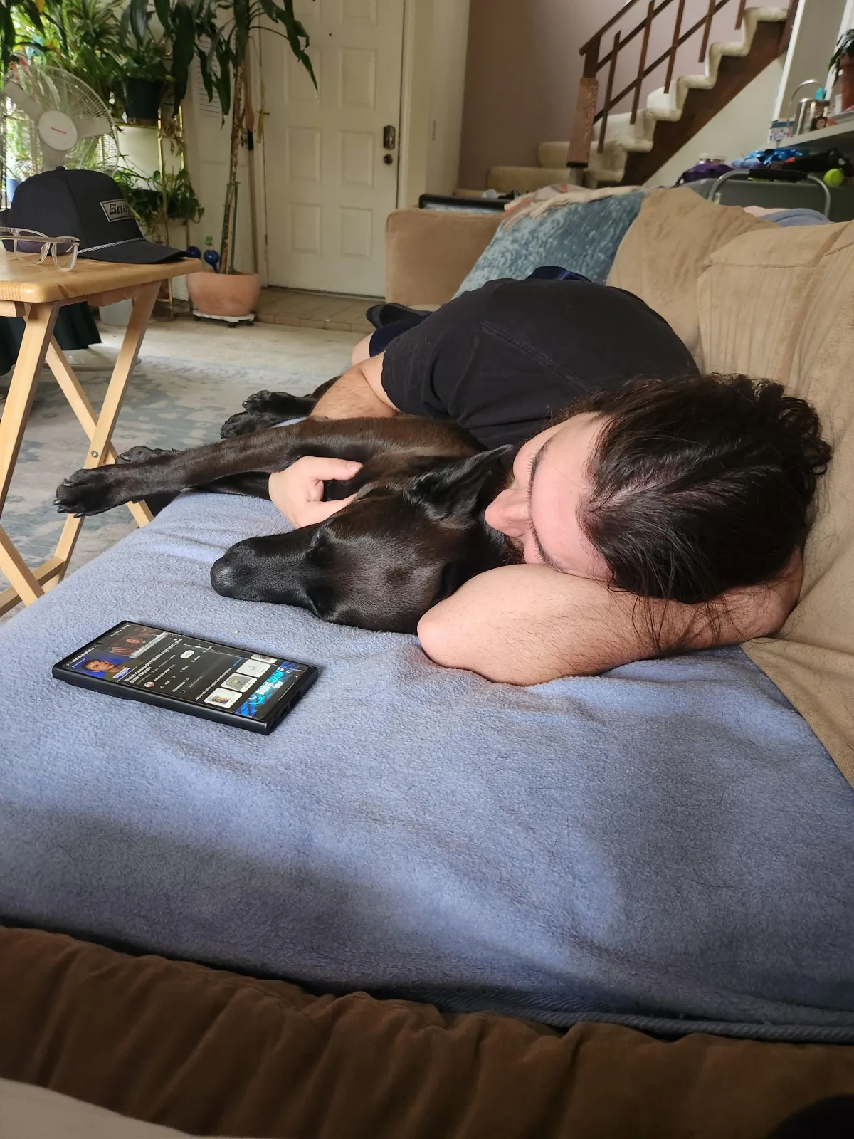 Snicki the dog laying with John