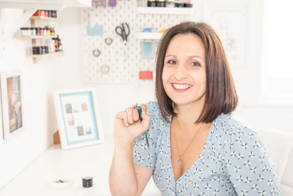 The Oxford Calligrapher with a pointed pen in her hand in the studio