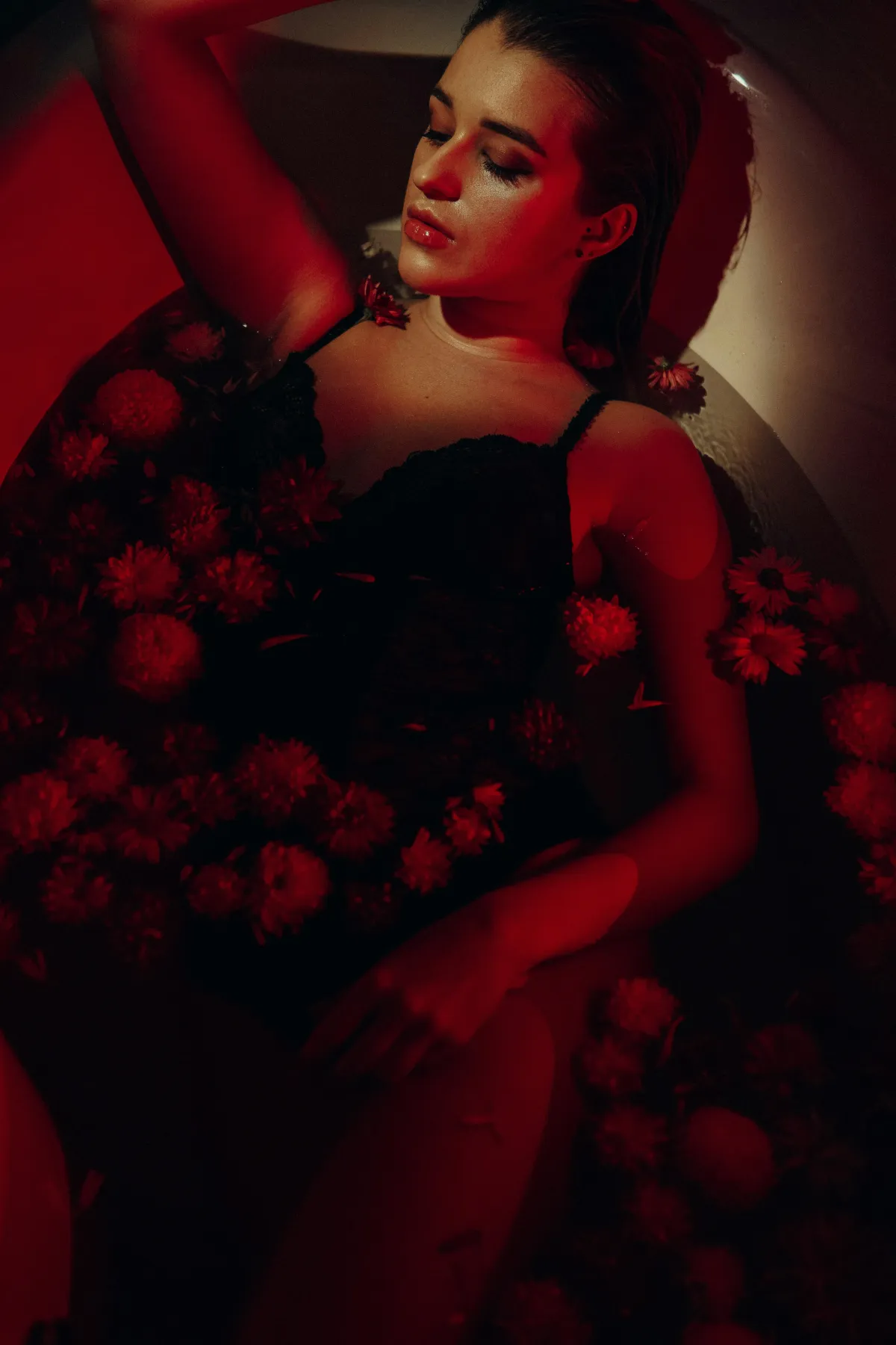 Stressed out woman in the bathtub with flowers