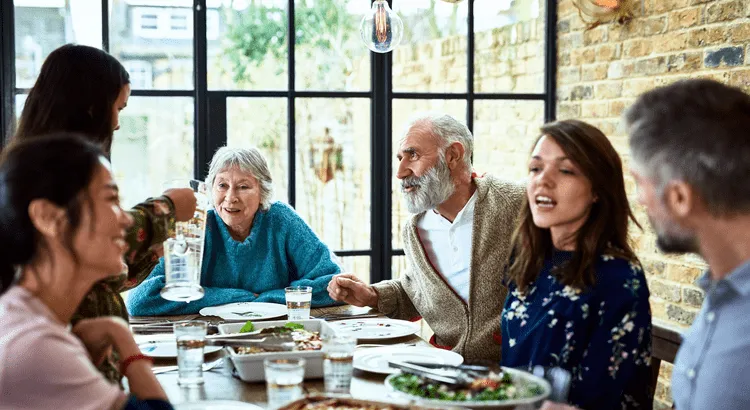 6 people having conversation during lunch at a beautiful dining table