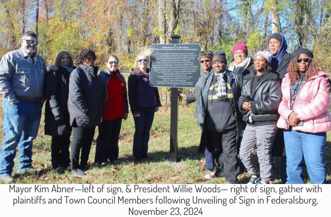 Mayor Kim Abner—left of sign, & President Willie Woods— right of sign, gather with plaintiffs and Town Council Members following Unveiling of Sign in Federalsburg, November 23, 2024